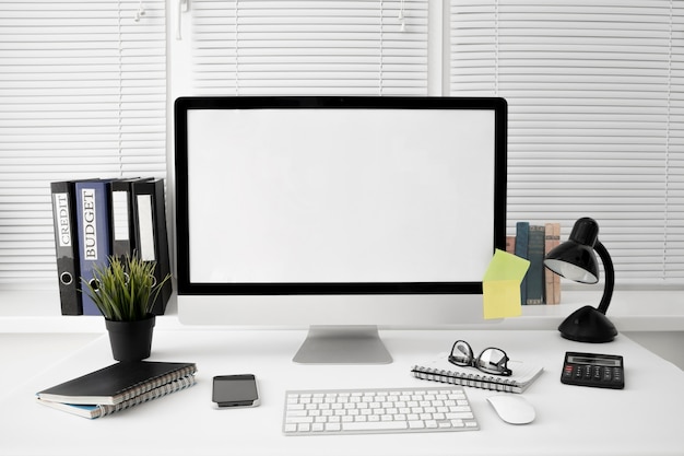 Free Photo front view of workspace with lamp and computer screen