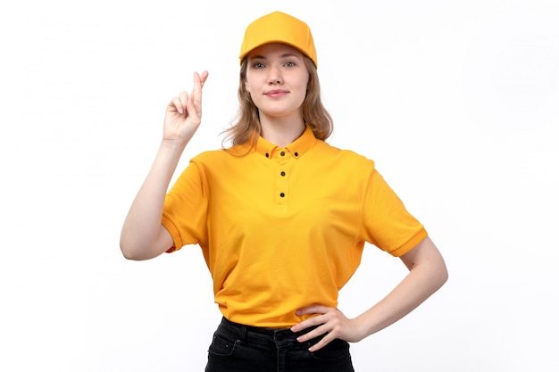 Free photo a front view young female courier female worker of food delivery service showing crossed fingers smiling on white