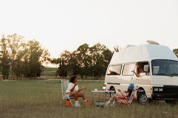 Free Photo full shot friends relaxing outdoors