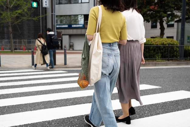 Free Photo full shot woman with fabric bag