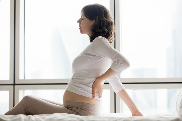 Free photo future mom suffering from spinal pain