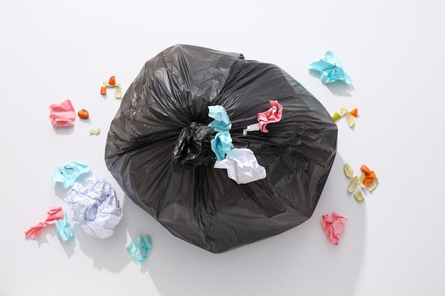 Free Photo garbage bag with rubbish and papers on white background top view