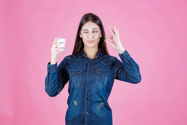 Free Photo girl in denim shirt having coffee and enjoying the taste