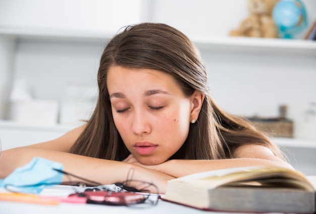 Free Photo girl is sleeping after studying