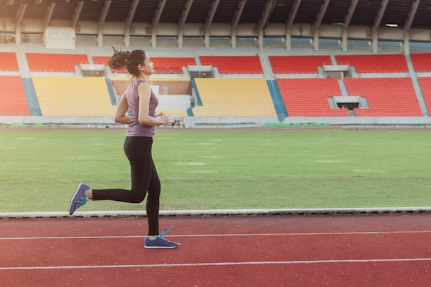 Free photo girl running on an athletic track