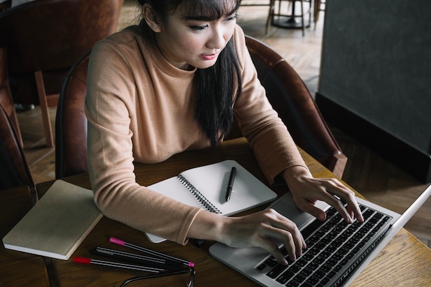 Free Photo girl typing on laptop