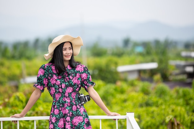 Free photo girl wearing a floral dress on the balcony