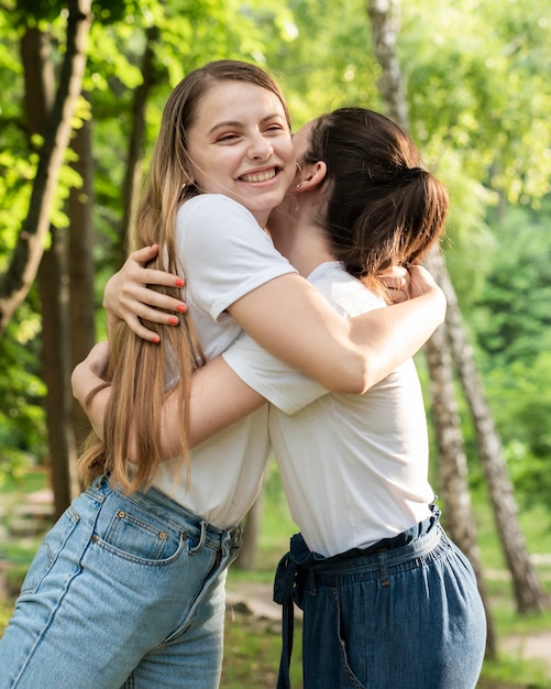 Free photo girls smiling and hugging each other