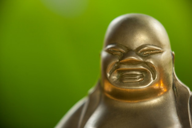 Free Photo gold painted laughing buddha figurine