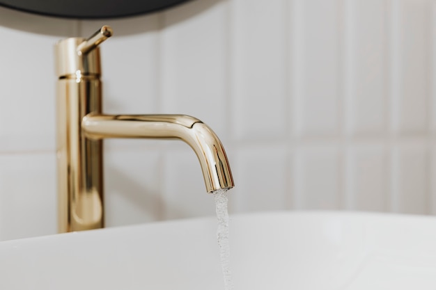 Free photo golden faucet with running water
