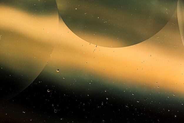 Gradient sepia oil drops on a water surface abstract background