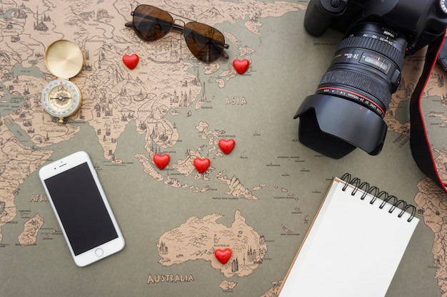 Free photo great composition with travel objects and decorative red hearts