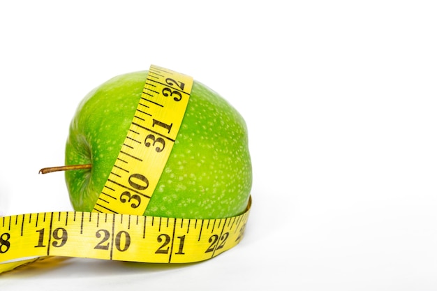 Free Photo green apple and meter on a white background isolated