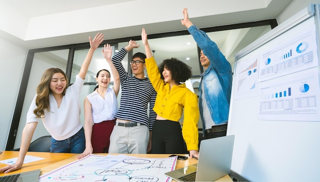 Free photo group of asian young creative happy people entrepreneur on a business meeting office background good leadership and teamwork lead to success