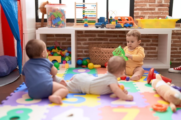 Free Photo group of toddlers playing with toys crawling on floor at kindergarten