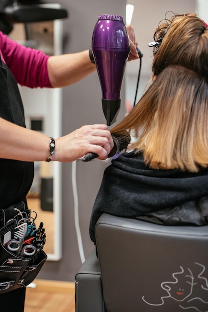 Hairdresser drying woman39s hair