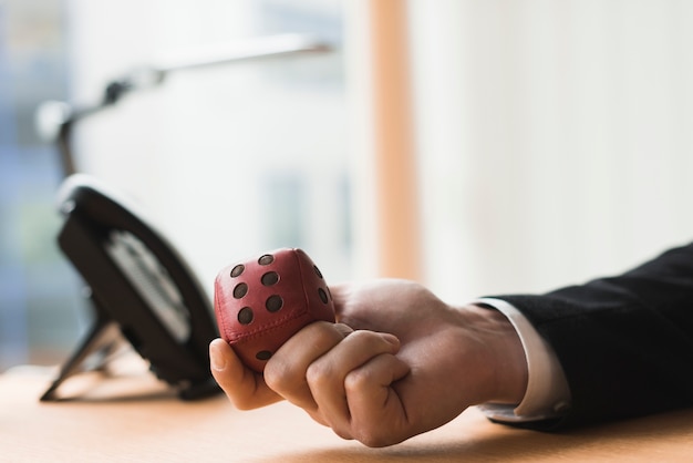 Free photo hand of businessman with toy