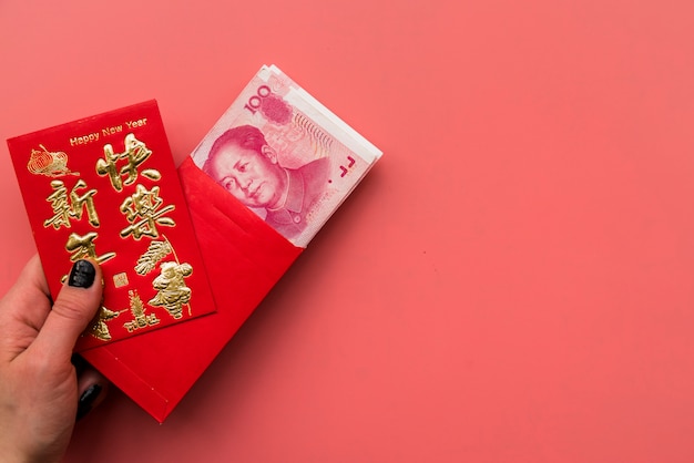 Free photo hand holding card and chinese bills