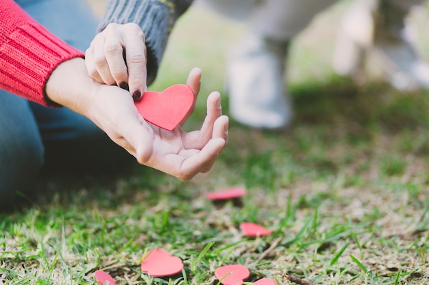 Free photo hands of couple with paper heart