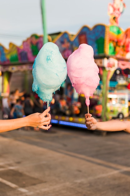 Free photo hands holding cotton candy