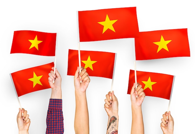 Free photo hands waving flags of vietnam