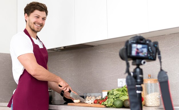 Handsome male recording cooking session