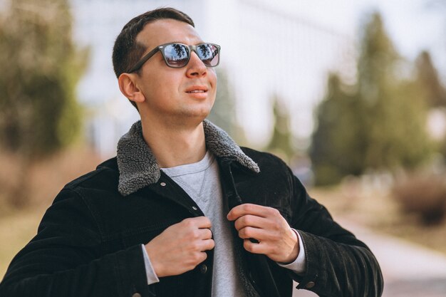 Free photo handsome man walking in park