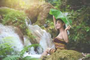 Free photo happy bathing women at the natural waterfall