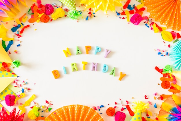 Free photo happy birthday text with party accessories on white background