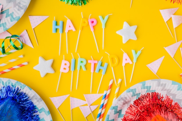 Free photo happy birthday writing amidst flags and plates