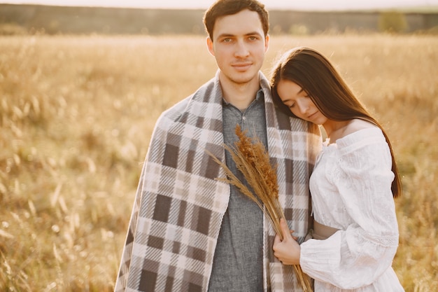 Free photo happy couple in love in wheat field at sunset