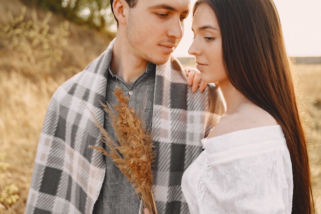 Free photo happy couple in love in wheat field at sunset