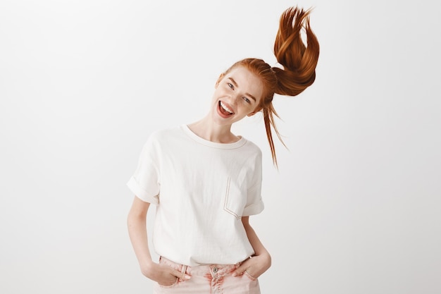 Free photo happy redhead girl whip ponytail and smiling carefree