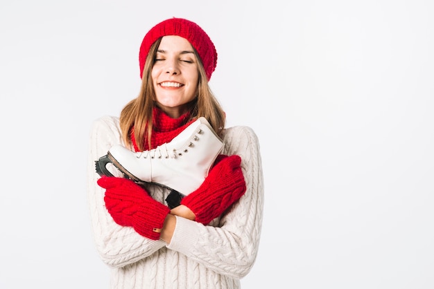 Free photo happy woman in sweater holding skate