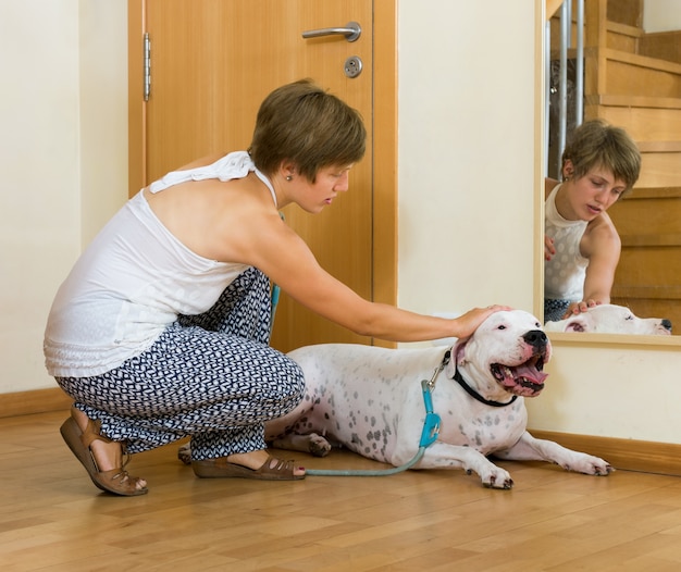 Free photo happy woman taking dog for a walk