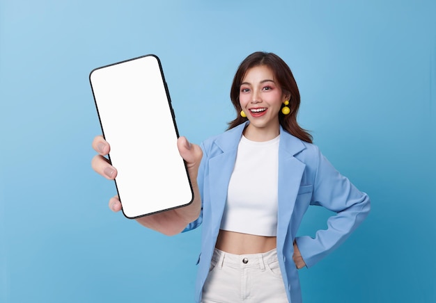 Free photo happy young beautiful asian business woman showing smartphone with blank screen mockup