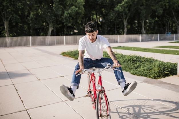 Happy young cyclist enjoying ride on his bicycle