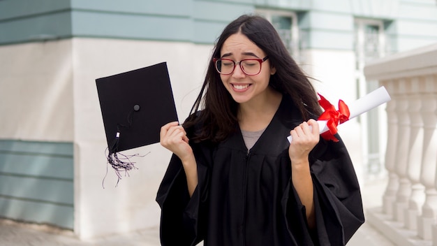 Free photo happy young woman at graduation ceremony