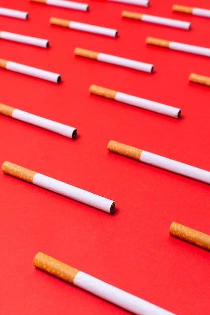 Free photo high angle cigarettes on red background