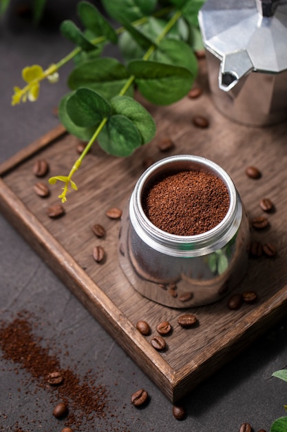 Free photo high angle coffee powder in container on wooden board