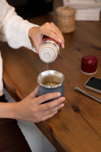 Free Photo high angle hand pouring drink