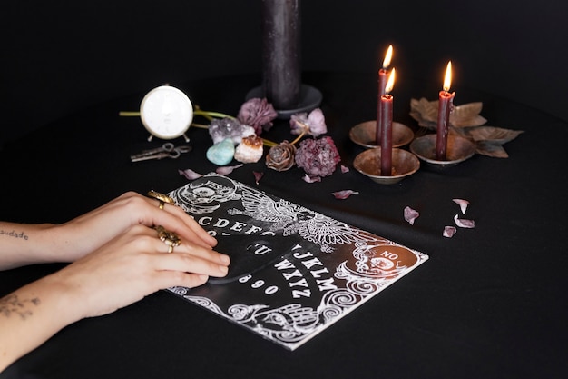 Free photo high angle hands using ouija board