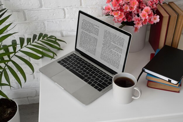 High angle laptop and books arrangement