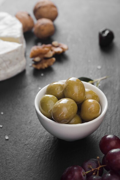 High angle olives and cheese composition on black background