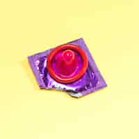 Free photo high angle unwrapped red condom