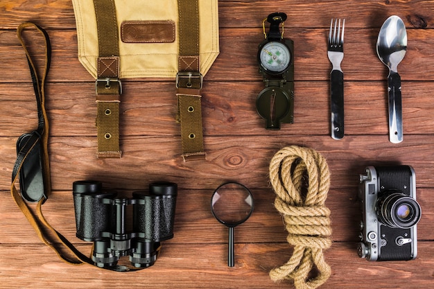 High angle view of camping equipments on wooden desk