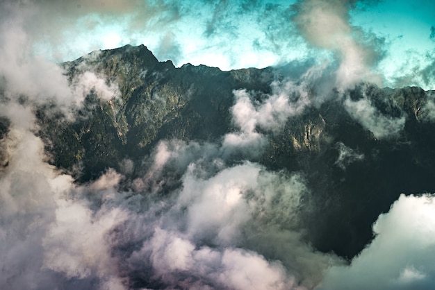 Free Photo high angle view of the clouds covering the rocky mountains