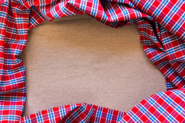 Free photo high angle view of plaid pattern textile forming frame