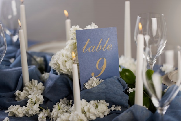 Free photo high angle wedding table number with candles