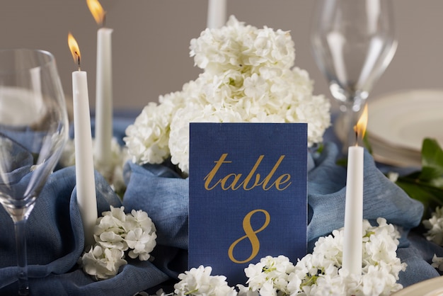 Free photo high angle wedding table number with candles